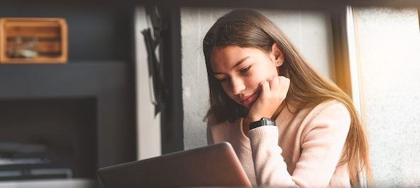 Young girl looking at a laptop